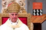 Rino Fisichella con la copertina del libro La forza della passione