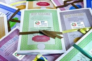 Certificati cartacei di Titoli di Stato italiani e BTP Valore con la dicitura "1000" e nastri colorati disposti uno sopra l'altro
